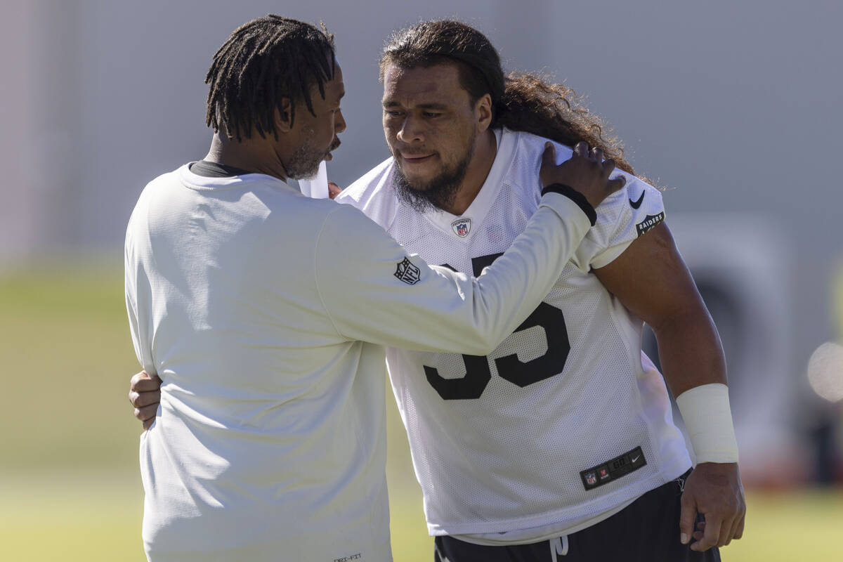 Raiders defensive coordinator Patrick Graham interacts with defensive tackle Leki Fotu (95) dur ...