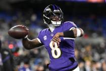 Baltimore Ravens quarterback Lamar Jackson (8) works out before an NFL football wild card playo ...