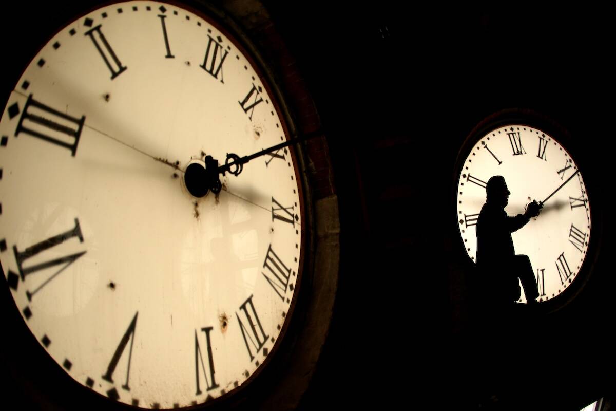 Custodian Ray Keen inspects a clock face before changing the time on the 100-year-old clock ato ...