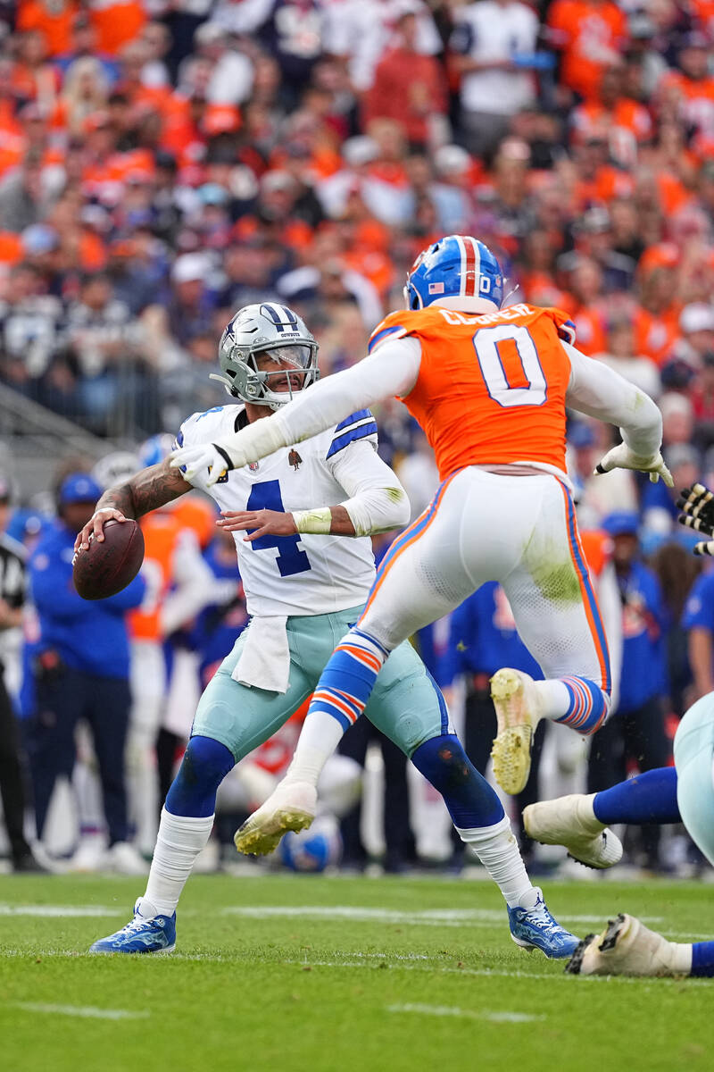 Dallas Cowboys quarterback Dak Prescott (4) drops back for a pass against the Denver Broncos du ...