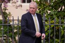 FILE - Prince Andrew looks round as he leaves after attending the Easter Matins Service at St. ...