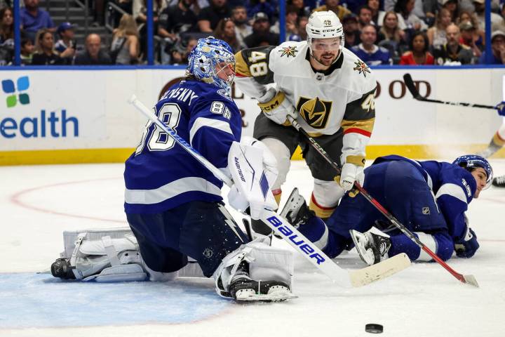 Tampa Bay Lightning goaltender Andrei Vasilevskiy, left, deflects the puck away from Vegas Gold ...
