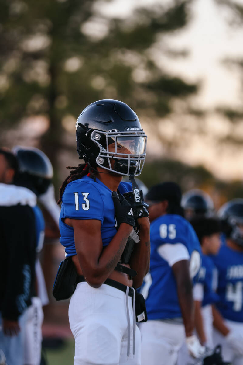 Desert Pines wide receiver/defensive back Maurice Busby (13) stands on the sidelines before the ...