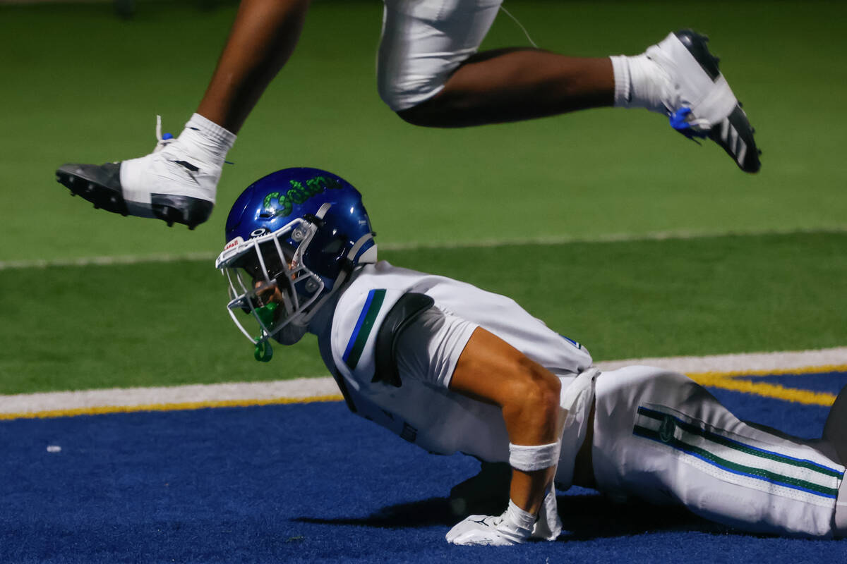 Desert Pines inside linebacker Ja'Mire Ross (17) leaps over Green Valley wide receiver Bo ...