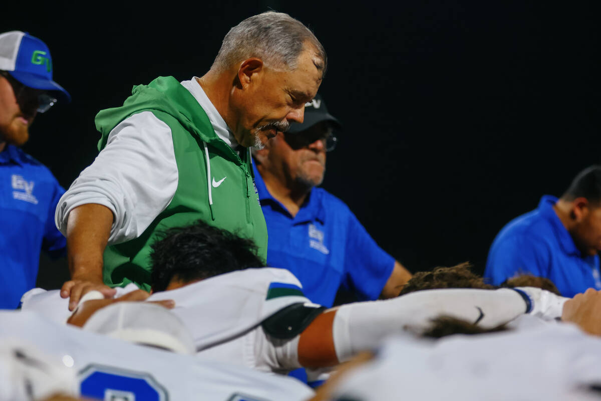 Green Valley head coach Bill Powell prays with his team after the Gators won the Class 5A South ...