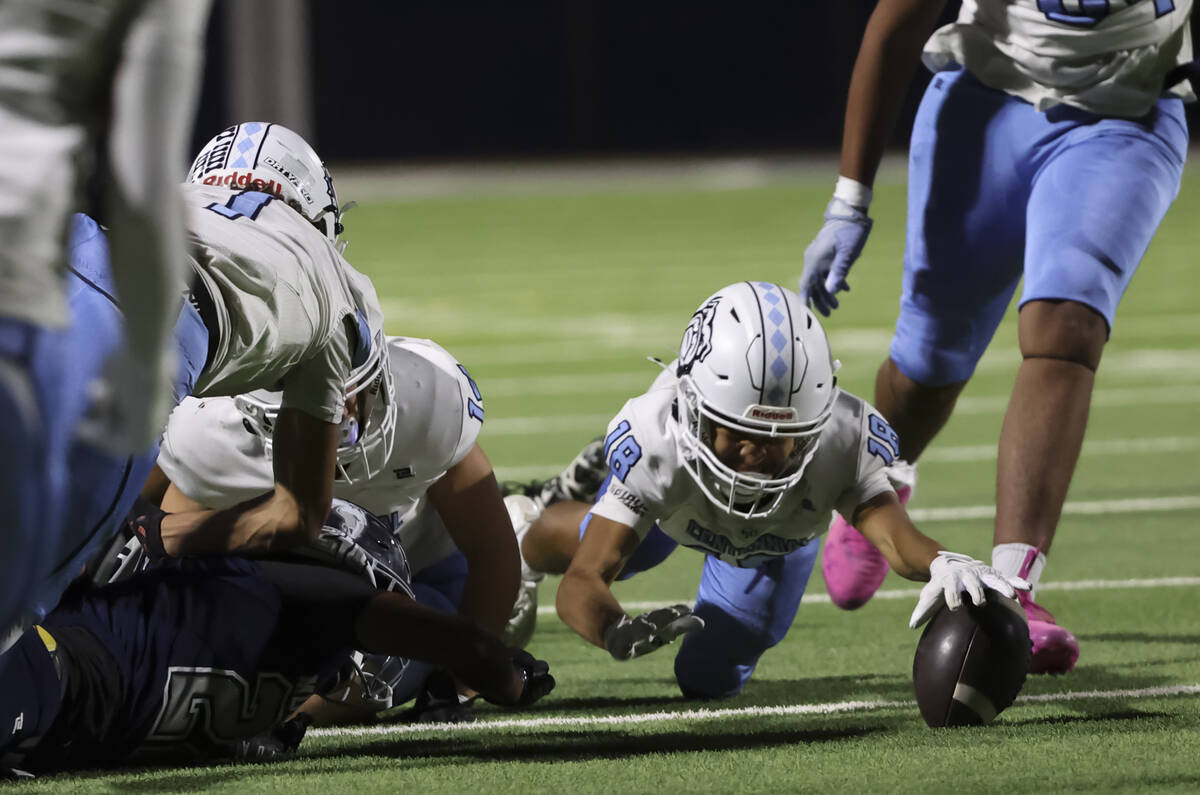 Centennial wide receiver Adrean Montano (18) dives for a fumbled ball during the first half of ...