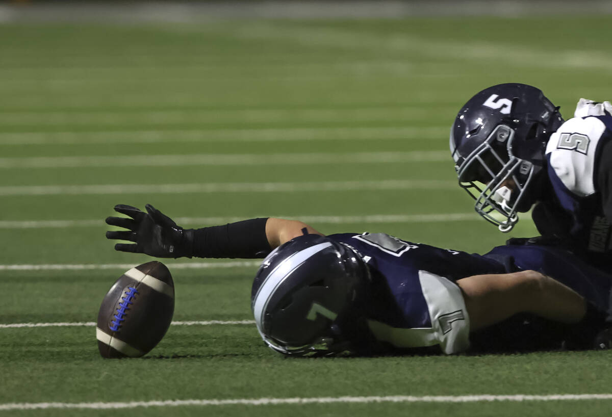 Shadow Ridge's Blake Holmstrom (7) tries to recover a fumbled ball during the first half o ...
