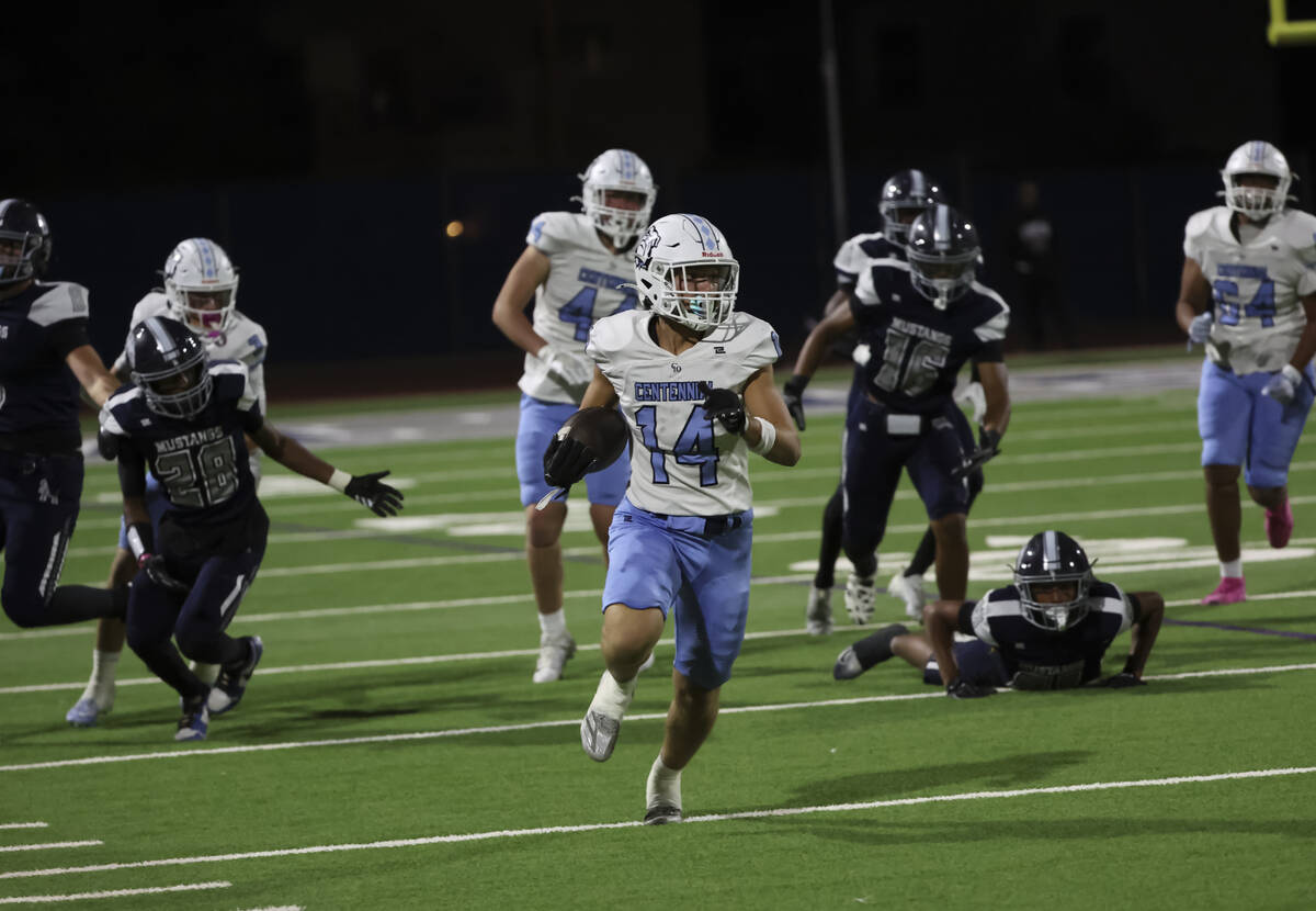 Centennial running back/wide receiver Brogan Church (14) pushes past Shadow Ridge's Charl ...