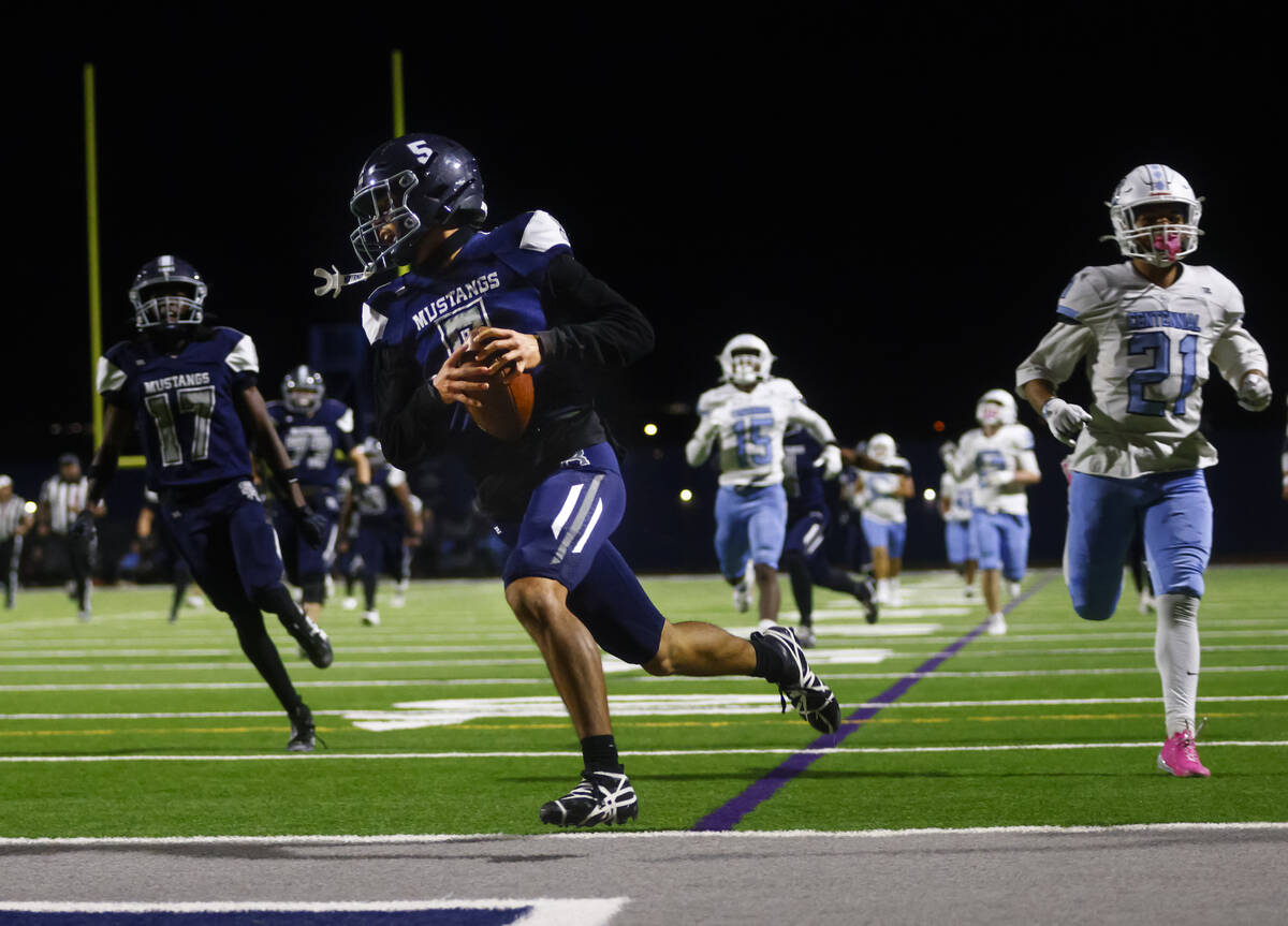 Shadow Ridge's Isaiah Ruiz (5) scores a touchdown against Centennial during the first half ...