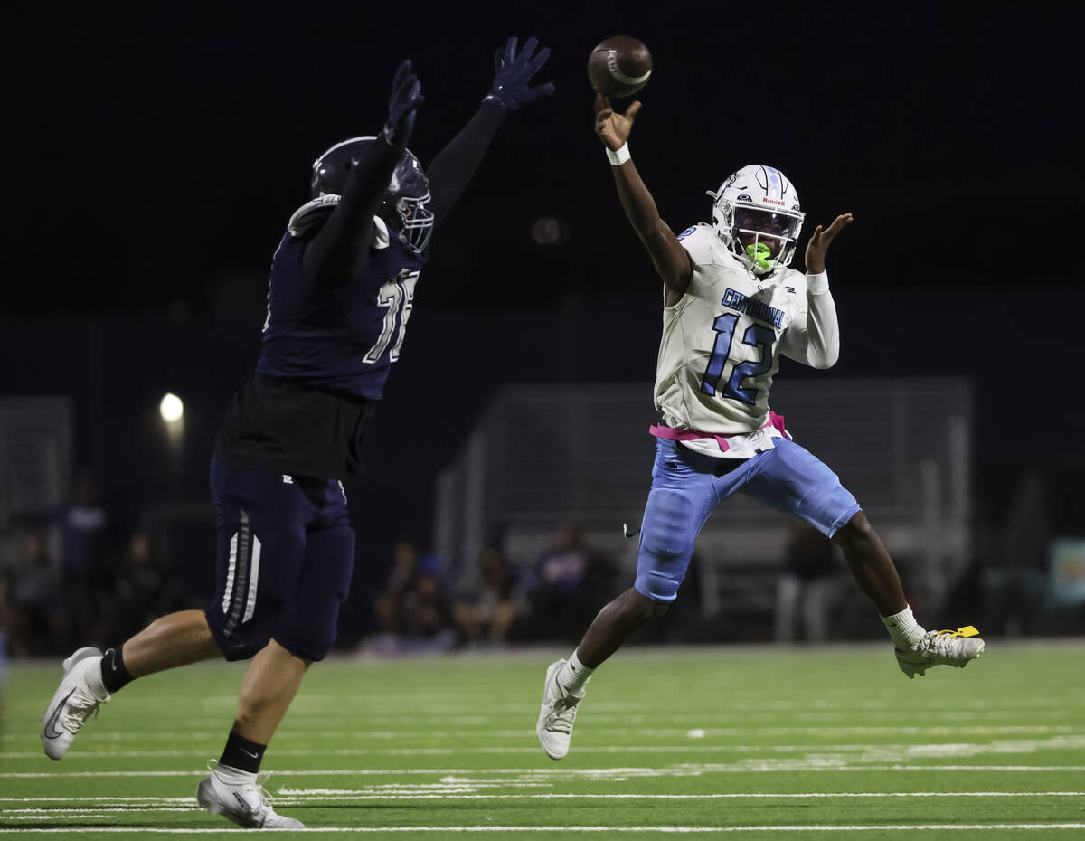 Centennial quarterback Nehemiah Dunlap Myvett (12) throws a pass under pressure from Shadow Ri ...