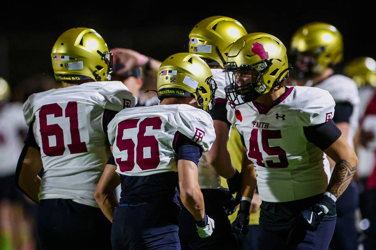 Faith Lutheran players celebrate during a class 5A Southern Region high school football playoff ...