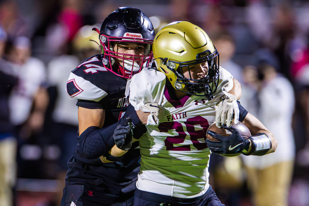Desert Oasis tackle/guard Missylosi Tauasosi (74) grabs hold of Faith Lutheran wide receiver R ...