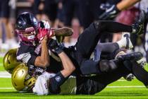 Desert Oasis wide receiver/cornerback Isaiah Reyes (6) is brought down by Faith Lutheran defend ...