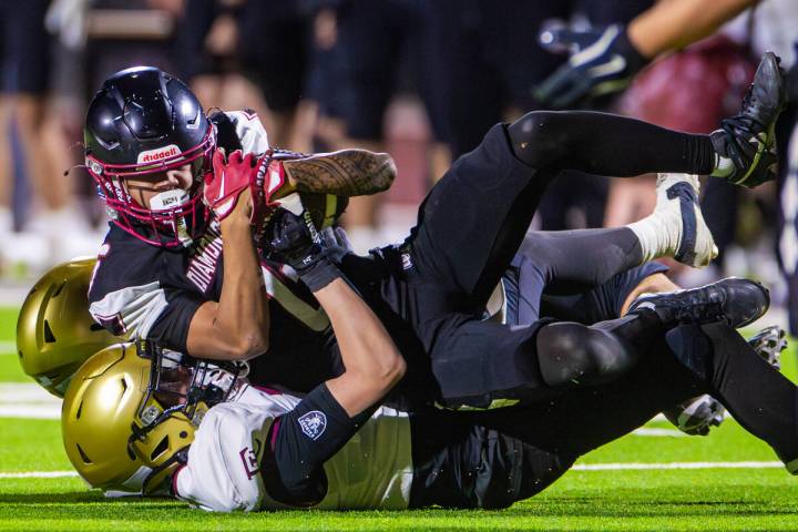 Desert Oasis wide receiver/cornerback Isaiah Reyes (6) is brought down by Faith Lutheran defend ...