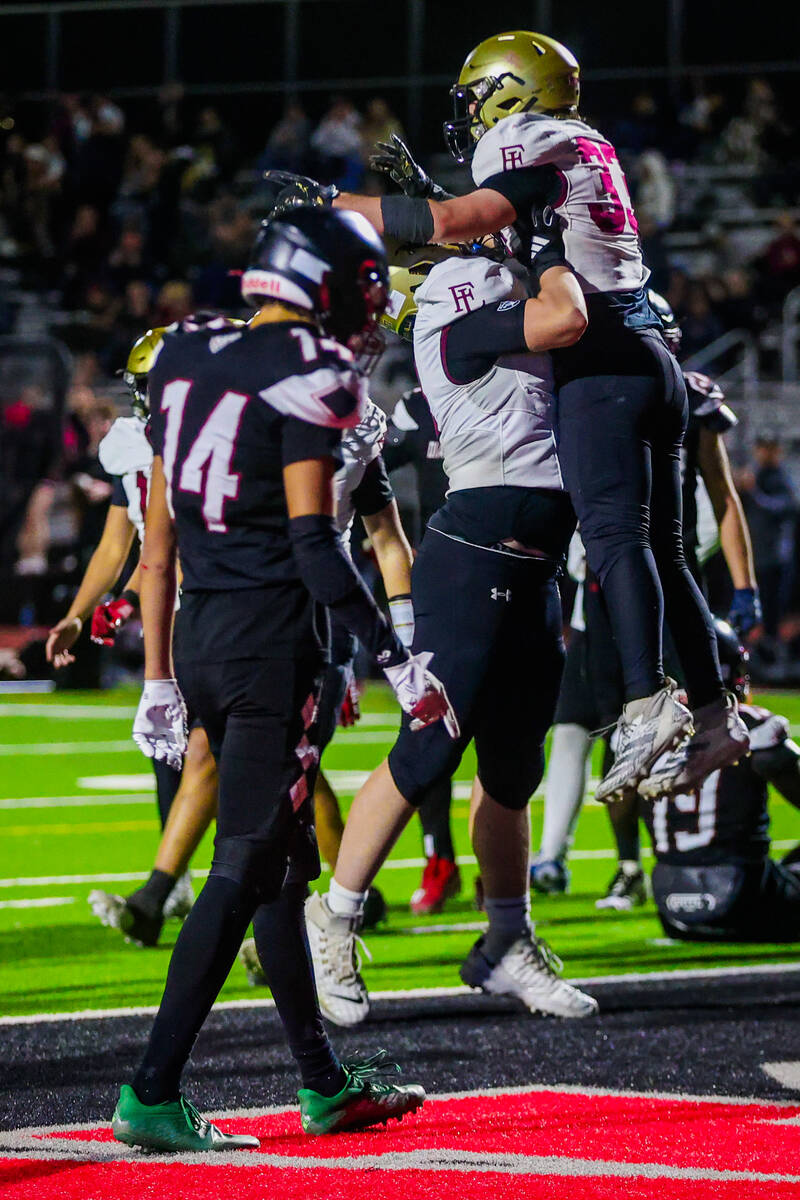 Faith Lutheran running back Justin Robbins (33) celebrates a touchdown during a class 5A South ...