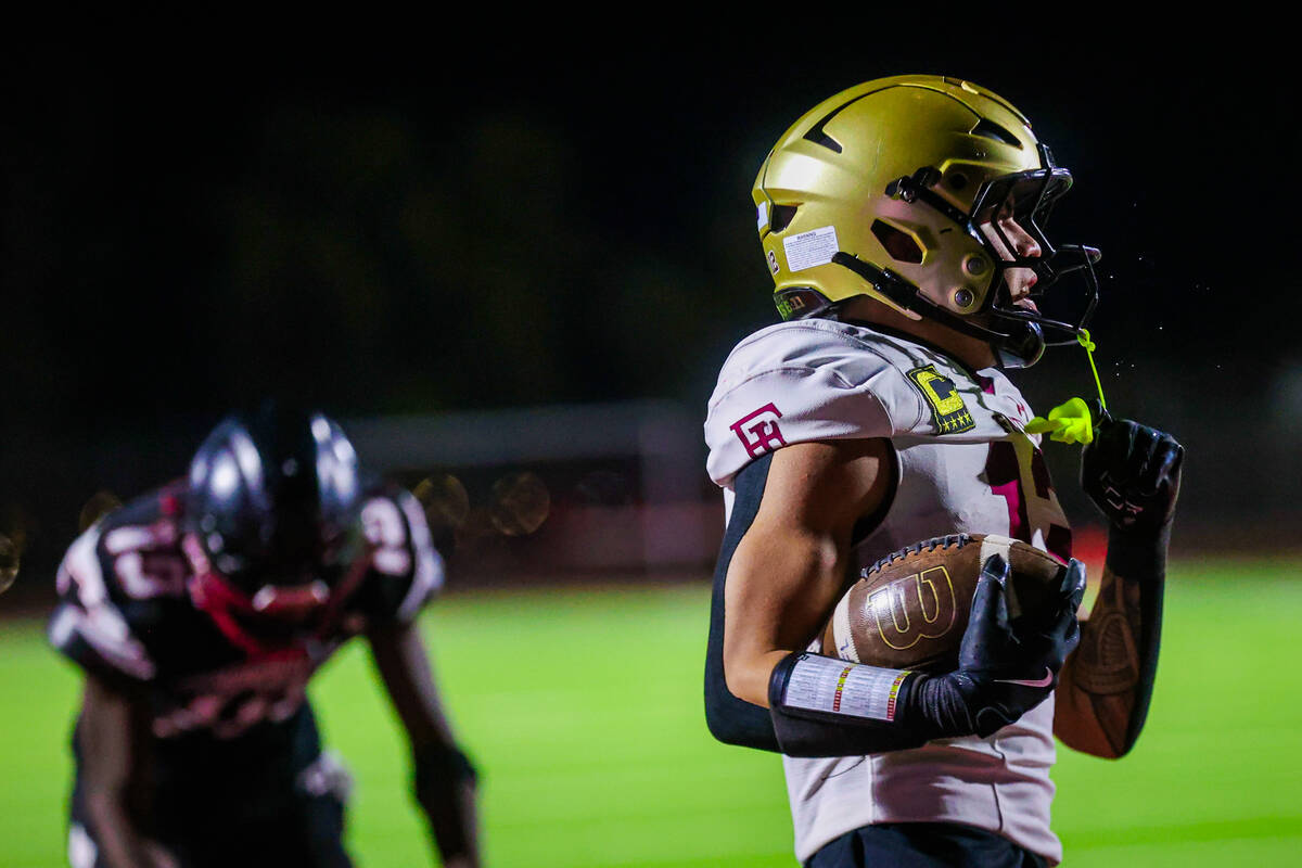 Faith Lutheran wide receiver Aipa Kuloloia (12) scores a touchdown during a class 5A Southern R ...