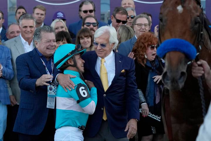 Martin Garcia (6) celebrates with horse trainer Bob Baffert, middle, after riding Citizen Bull ...
