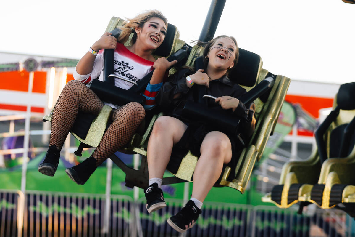 Genesis Castor, 15, left, Emma Celeste, 15, take in a ride at Halloween Town LV Thursday, Oct. ...