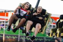 Genesis Castor, 15, left, Emma Celeste, 15, take in a ride at Halloween Town LV Thursday, Oct. ...