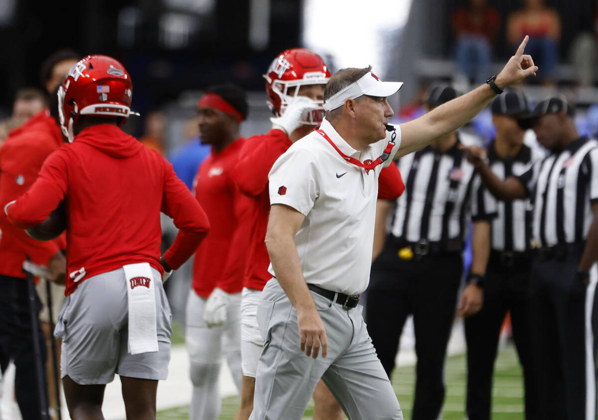 UNLV head coach Daniel Mullen signals as his players prepare to warm up to face Air Force Falco ...