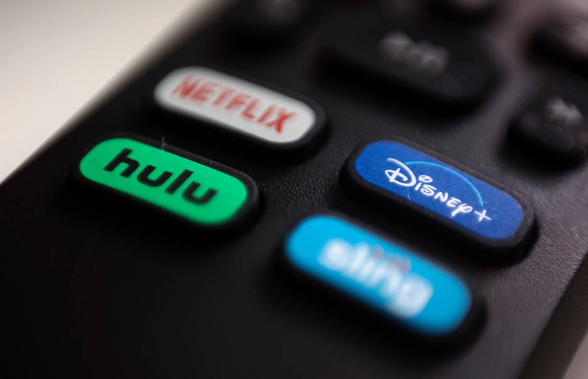 FILE - The logos for streaming services Netflix, Hulu, Disney Plus and Sling TV are pictured on ...