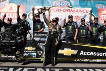 Top Fuel driver Brittany Force, center, celebrates her win following the NHRA Nationals at the ...