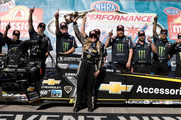 Top Fuel driver Brittany Force, center, celebrates her win following the NHRA Nationals at the ...