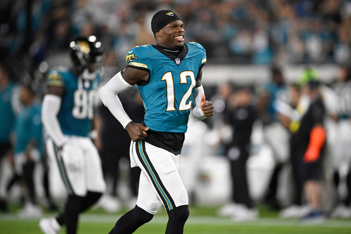Jacksonville Jaguars wide receiver Travis Hunter (12) runs on the field before an NFL football ...
