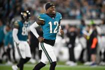 Jacksonville Jaguars wide receiver Travis Hunter (12) runs on the field before an NFL football ...