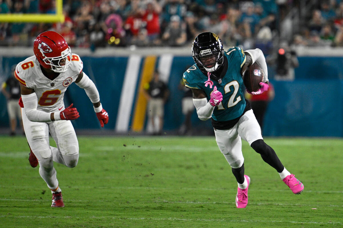 Jacksonville Jaguars wide receiver Travis Hunter (12) runs after catching a pass in front of Ka ...