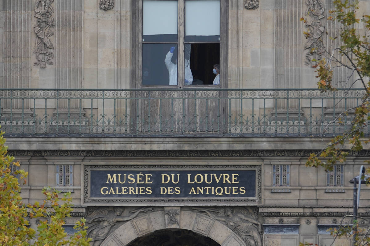 Police officers work inside the Louvre museum, Sunday, Oct. 19, 2025 in Paris. (AP Photo/Thibau ...