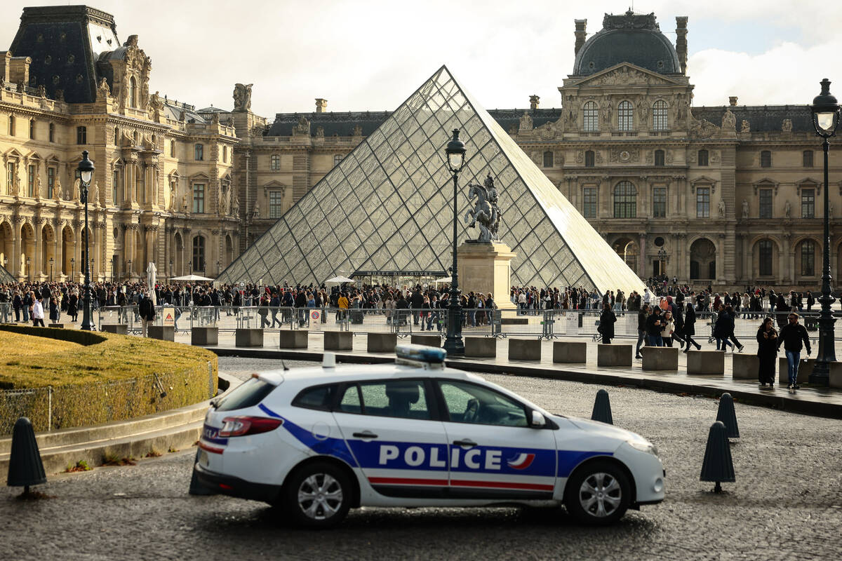 A police car parks in the courtyard of the Louvre museum, one week after the robbery, Sunday, O ...