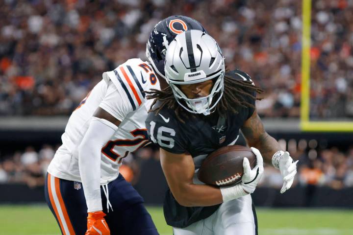 Raiders wide receiver Jakobi Meyers (16) protects the ball from Chicago Bears cornerback Nahsho ...