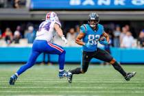 Carolina Panthers tight end Tommy Tremble (82) tires to avoid the tackle by Buffalo Bills lineb ...