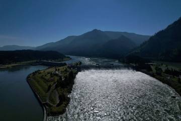 FILE - Water spills over the Bonneville Dam on the Columbia River, which runs along the Washing ...