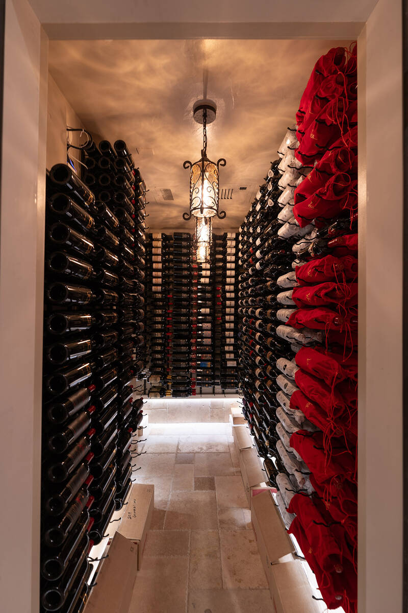 The home’s expansive wine storage stands out as a centerpiece, a climate-controlled, wrap-aro ...