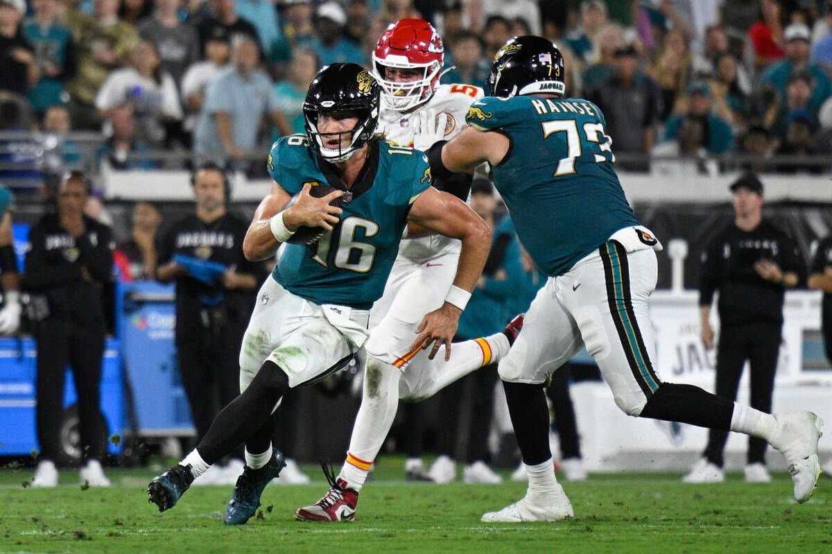 Jacksonville Jaguars quarterback Trevor Lawrence (16) scrambles for yardage against the Kansas ...