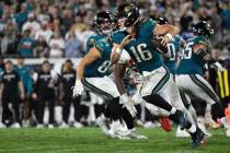 Jacksonville Jaguars quarterback Trevor Lawrence (16) scrambles for yardage against the Kansas ...