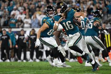 Jacksonville Jaguars quarterback Trevor Lawrence (16) scrambles for yardage against the Kansas ...