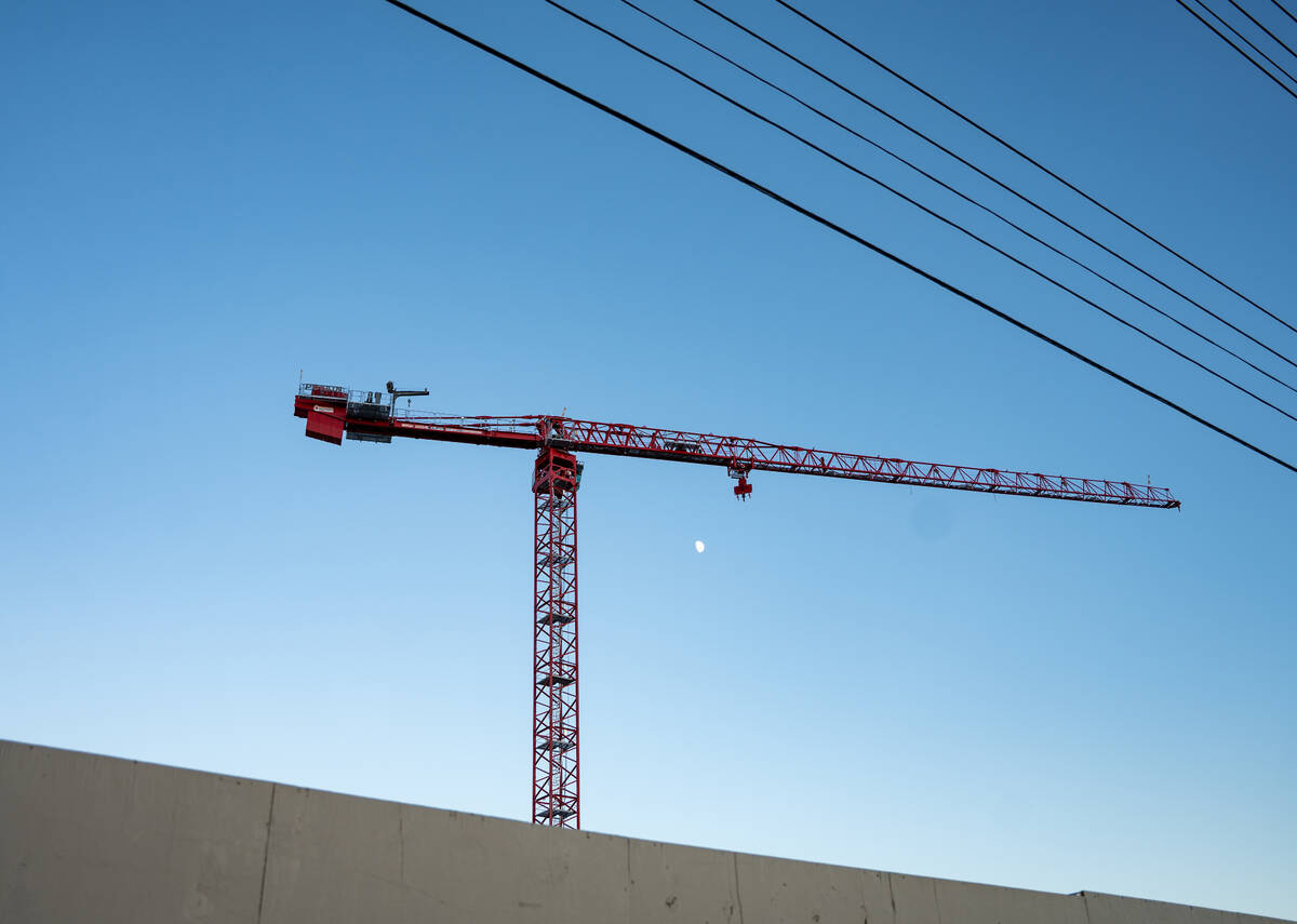 A crane looms over the Dream Hotel project site next to the Pinball Hall of Fame Friday evening ...