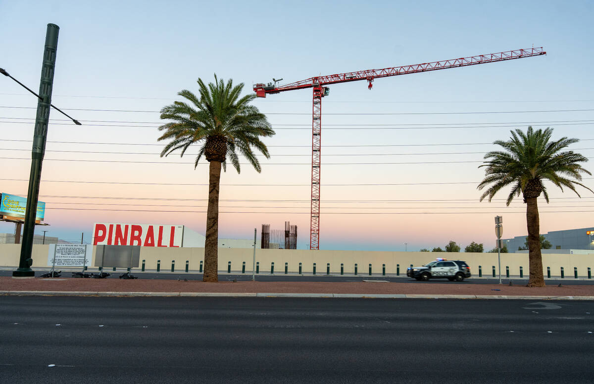 A police car passes the Dream Hotel project site neighboring the Pinball Hall of Fame Friday ev ...
