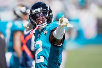 Jacksonville Jaguars wide receiver Travis Hunter points forward after making a first down again ...