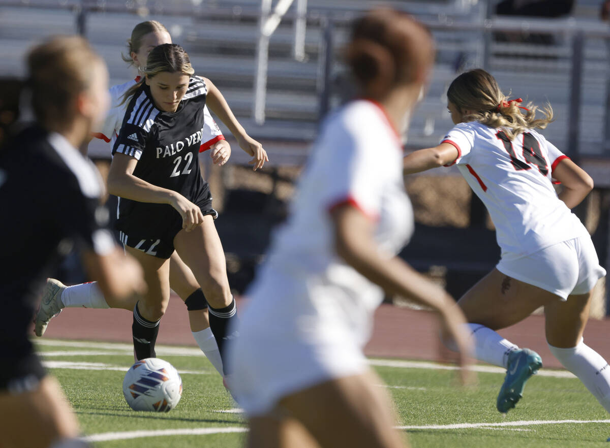 Palo Verde midfielder Caitlynn Nick (22) drives the ball against Doral Academy defense, includi ...