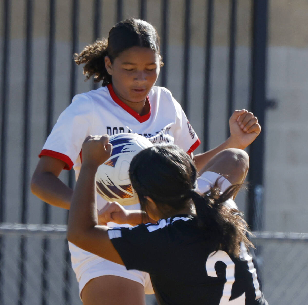Palo Verde defense Natalie Reyes (21) collides with Doral Academy midfield Jasmine Pichay durin ...