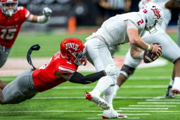 UNLV defensive back Jaheem Joseph (3) sacks New Mexico Lobos quarterback Jack Layne (2) as he m ...