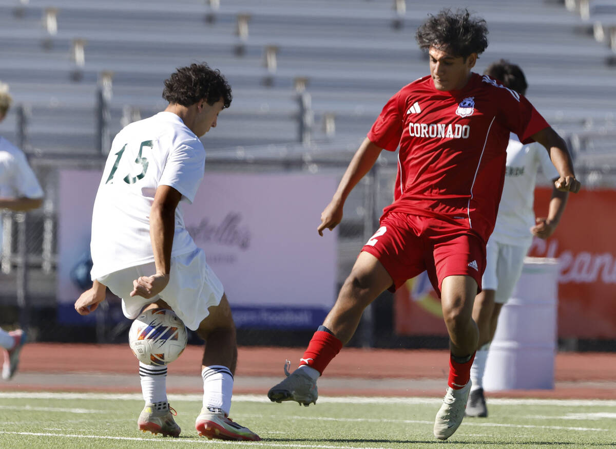 Coronado midfielder Liam Bringhurst (12) passes the ball between Palo Verde forward Trevon Aytc ...