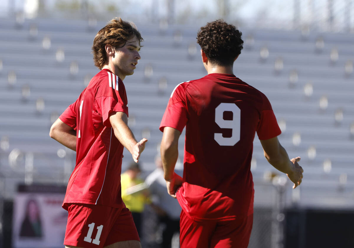 Coronado striker Gavin Flickinger (11) celebrates his goal with midfielder Dylan Flores (9) dur ...