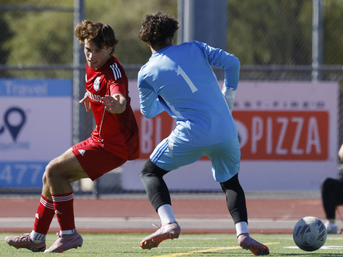 Palo Verde goalkeeper Jake Barrett blocks the ball as Coronado striker Gavin Flickinger (11) at ...