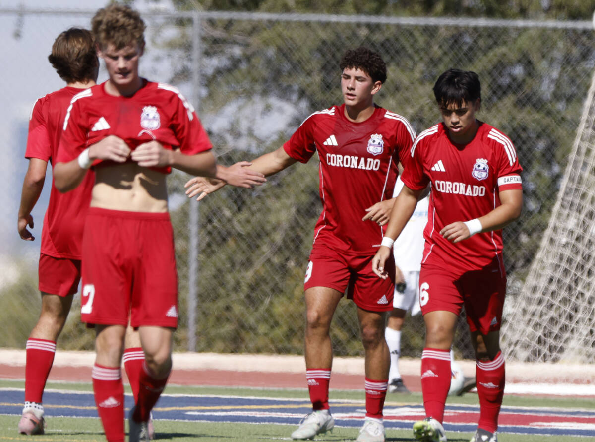 Coronado midfielder Dylan Flores, center, celebrates his goal with teammates during a Class 5A ...
