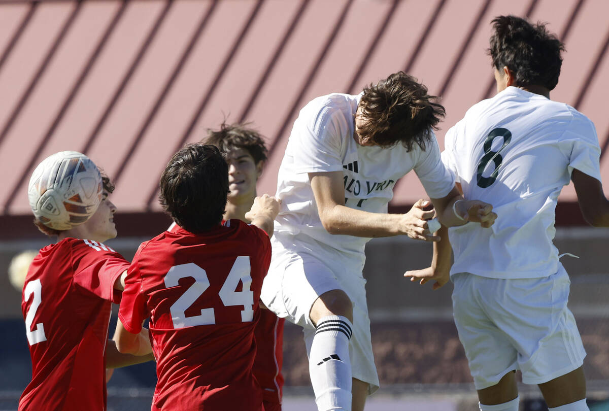Palo Verde Haydn Rodrigues, center, goes for a header against Coronado defense during a Class 5 ...